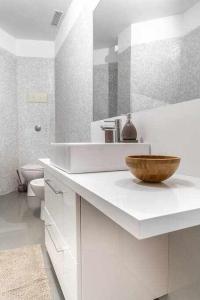 a white bathroom with a sink and a toilet at Attic floor venice apartment in Mestre