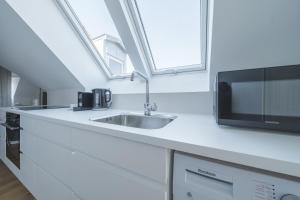 a kitchen with a sink and a microwave at Beautiful 1-BR apartment in a fantastic location - 211 in Aarhus