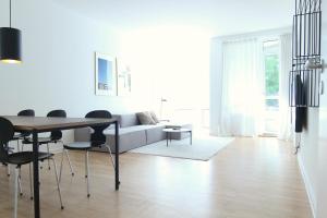 a living room with a table and a couch at Wonderful 2-bed wbalcony in top Frederiksberg location in Copenhagen
