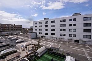 a large white building with a pool in front of it at Cool 1-bed with private terrace in Copenhagen