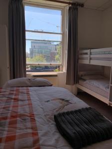 a bedroom with a bed and a large window at Eden Quay Guesthouse Private Rooms in Dublin