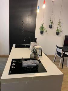 a kitchen with a stove with a tea kettle on it at IL GINEPRO house in Cagliari +2 photos