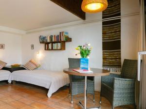 Zimmer mit einem Bett, einem Tisch und Stühlen in der Unterkunft Apartment Villaggio Sureggio - App- A 1 by Interhome in Lugaggia