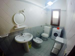 a bathroom with a sink and a toilet and a mirror at RESIDENCE 3 STARs SAN VITO LO CAPO in San Vito lo Capo