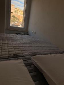 a bedroom with two beds and a window at IL GINEPRO house in Cagliari