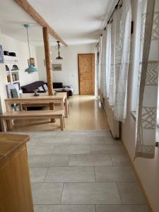 a living room with a tile floor and a table at Ratstraße im Kyffhäuser - krumm & schief in Bad Frankenhausen