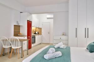 a white room with a bed and a kitchen at Centro Apartments by Comfortbnb- Sitia in Sitia +40 photos