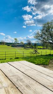 a wooden boardwalk in front of a green field at Beachborough Country House in Barnstaple