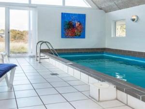 a swimming pool in a house at Holiday Home Herma - all inclusive - 1km from the sea by Interhome in Fanø