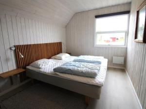 a bedroom with a bed in a room with a window at Holiday Home Herma - all inclusive - 1km from the sea by Interhome in Fanø