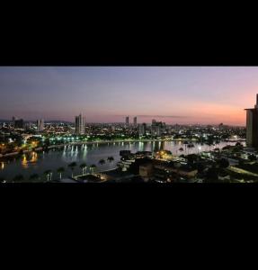 a view of a city at night with a river at Flat na melhor localização in Campina Grande +4 photos