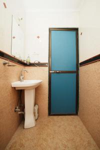 a bathroom with a sink and a mirror at Springfield Family Apartment in Mahabaleshwar