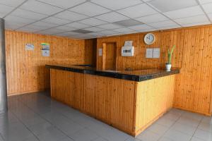 a room with a counter with a clock on the wall at Apartamentos LIVVO Puerto Bello in Puerto Rico de Gran Canaria +23 photos