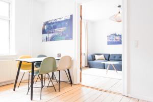a living room with a table and chairs and a couch at Spacious and cool 1-bed in Øgadekvarteret - 57 in Aarhus
