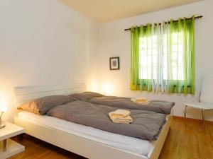 - une chambre avec un lit et 2 serviettes dans l'établissement Apartment Residence Miralago - Utoring Apt- D32 by Interhome, à Piazzogna