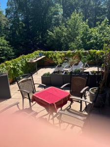 a patio table and chairs with a red blanket on it at Ferienwohnung „ Hospitalhütte“ in Dahlen