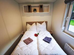 a bed in a small room with two pillows at Holiday Home Tiny Haus Christas Angler-Oase by Interhome in Riedenburg