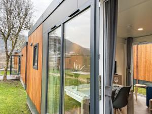 a glass house with a view of the yard at Holiday Home Tiny Haus Christas Angler-Oase by Interhome in Riedenburg