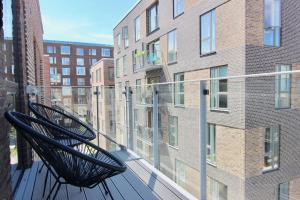 a balcony with a bench on top of a building at Fantastic 1-bed w balcony in Ørestaden in Copenhagen