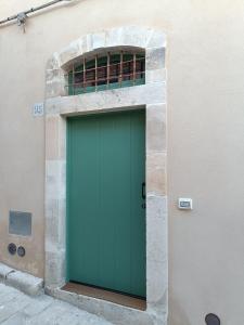 a green door on the side of a building at Casetta Santa Venera in Modica