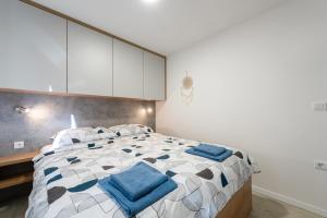 a bedroom with a large bed with blue pillows at Luxury mobile home HIMALAJA, Oaza mira, Drage in Drage
