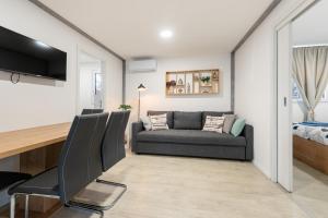 a living room with a couch and a table at Luxury mobile home HIMALAJA, Oaza mira, Drage in Drage +10 photos