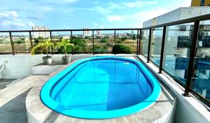 a swimming pool on the balcony of a building at Flat Sand Beach-IntermaresPB in Cabedelo