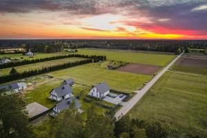 an aerial view of a house in a field at sunset at Gościniec Wigry 1 in Walne