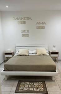 a bedroom with a bed with two tables and two signs at Nonna Maria in Bari