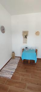 a room with a blue table and a floor at White Lotus seaside studio in Kinion