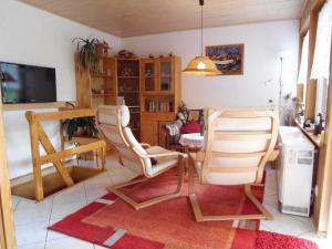 a living room with two chairs and a table at Ferienhaus "Hauß" Objekt ID 12063-3 in Waren