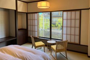 Postel nebo postele na pokoji v ubytování Akaishiya 城崎温泉旅館 赤石屋