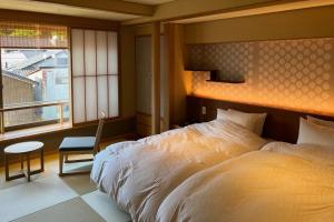 Postel nebo postele na pokoji v ubytování Akaishiya 城崎温泉旅館 赤石屋