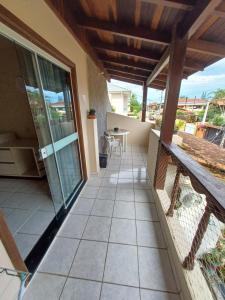 a balcony of a house with a table at Lagoa Center House in Florianópolis