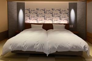 Postel nebo postele na pokoji v ubytování Akaishiya 城崎温泉旅館 赤石屋