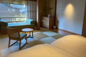 Postel nebo postele na pokoji v ubytování Akaishiya 城崎温泉旅館 赤石屋