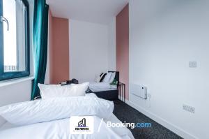 two beds in a room with white sheets and pillows at 25 percent OFF Monthly Stay By NYOS PROPERTIES Short Lets & Serviced Accommodation Manchester Business Leisure in Manchester