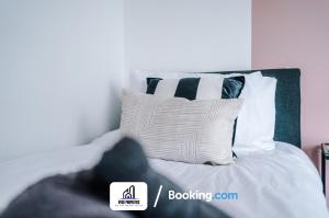 a bedroom with a bed with white sheets and pillows at 25 percent OFF Monthly Stay By NYOS PROPERTIES Short Lets & Serviced Accommodation Manchester Business Leisure in Manchester
