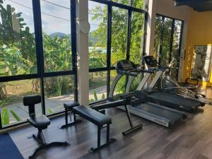 a gym with two tread machines and windows at Kathu Golf in Kathu