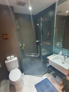 a bathroom with a shower and a toilet and a sink at Kathu Golf in Kathu