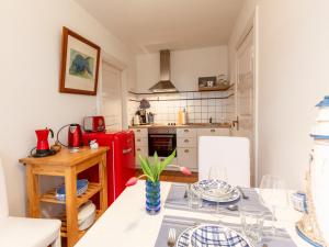 cocina con mesa y nevera roja en Apartment Gut Hörne-2 by Interhome, en Hörne