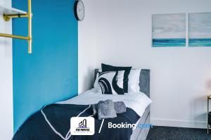 a bedroom with a bed with a clock on the wall at 25 percent OFF Monthly Stay By NYOS PROPERTIES Short Lets & Serviced Accommodation Manchester Business Leisure in Manchester