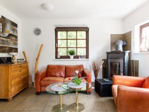 a living room with a couch and a table at Chalet Am Fleet by Interhome in Osten