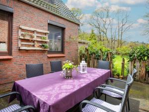 a table with a purple table cloth on a patio at Apartment Waldblick-2 by Interhome in Armstorf