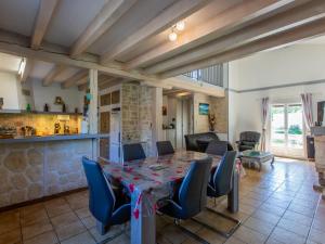 a dining room with a table and chairs at Holiday Home Labenne Océan - LBE115 by Interhome in Labenne