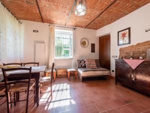 a living room with a table and a chair at Holiday Home Il Valletto by Interhome in Mombaruzzo