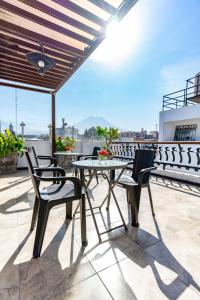 a patio with a table and chairs on a roof at Casona Terrace Hotel in Arequipa