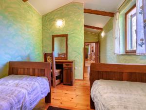 Łóżko lub łóżka w pokoju w obiekcie Holiday Home Narcis by Interhome