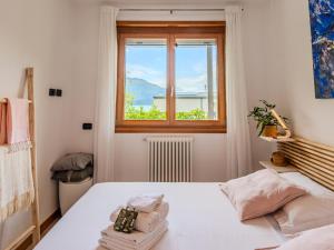a bedroom with a bed and a window at Apartment San Vincenzo by Interhome in Gera Lario