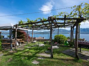 a pergola with a view of the water at Holiday Home Meri by Interhome in Cannero Riviera